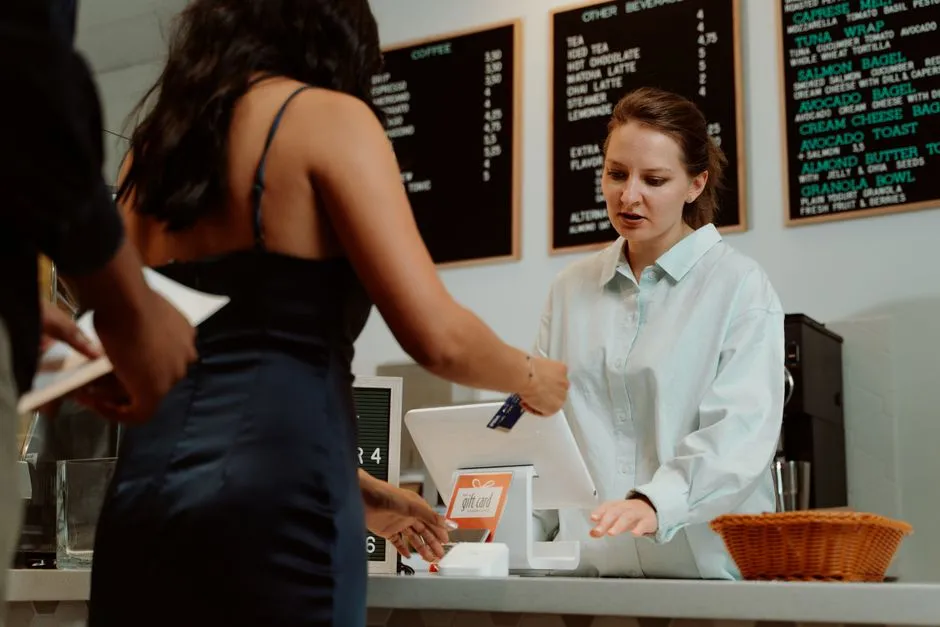Shopper paying at a grocery store checkout counter