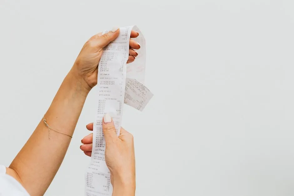 Shopper reviewing a grocery store receipt
