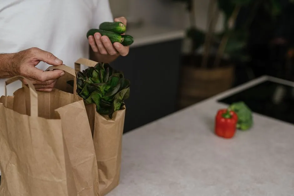 Fresh produce packed in a brown paper grocery bag